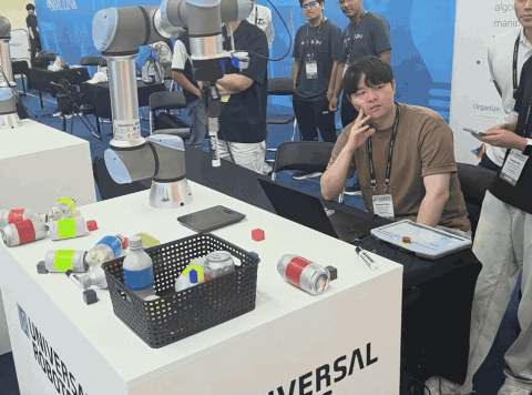 UOS Robotics team members watching the physical UR5e operate at the RoboCup 2026 ARM Challenge.